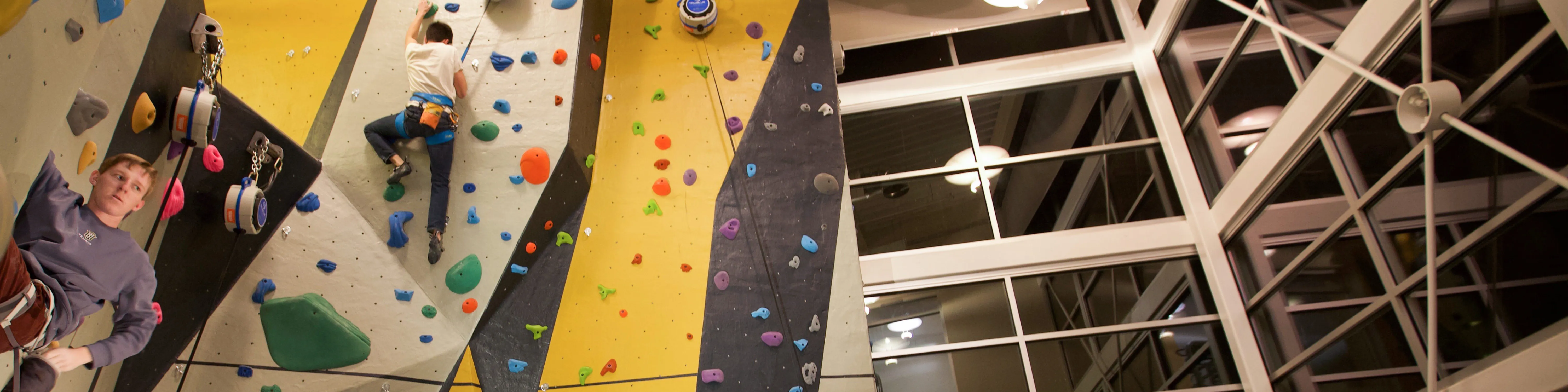 students climbing on the indoor climbing wall